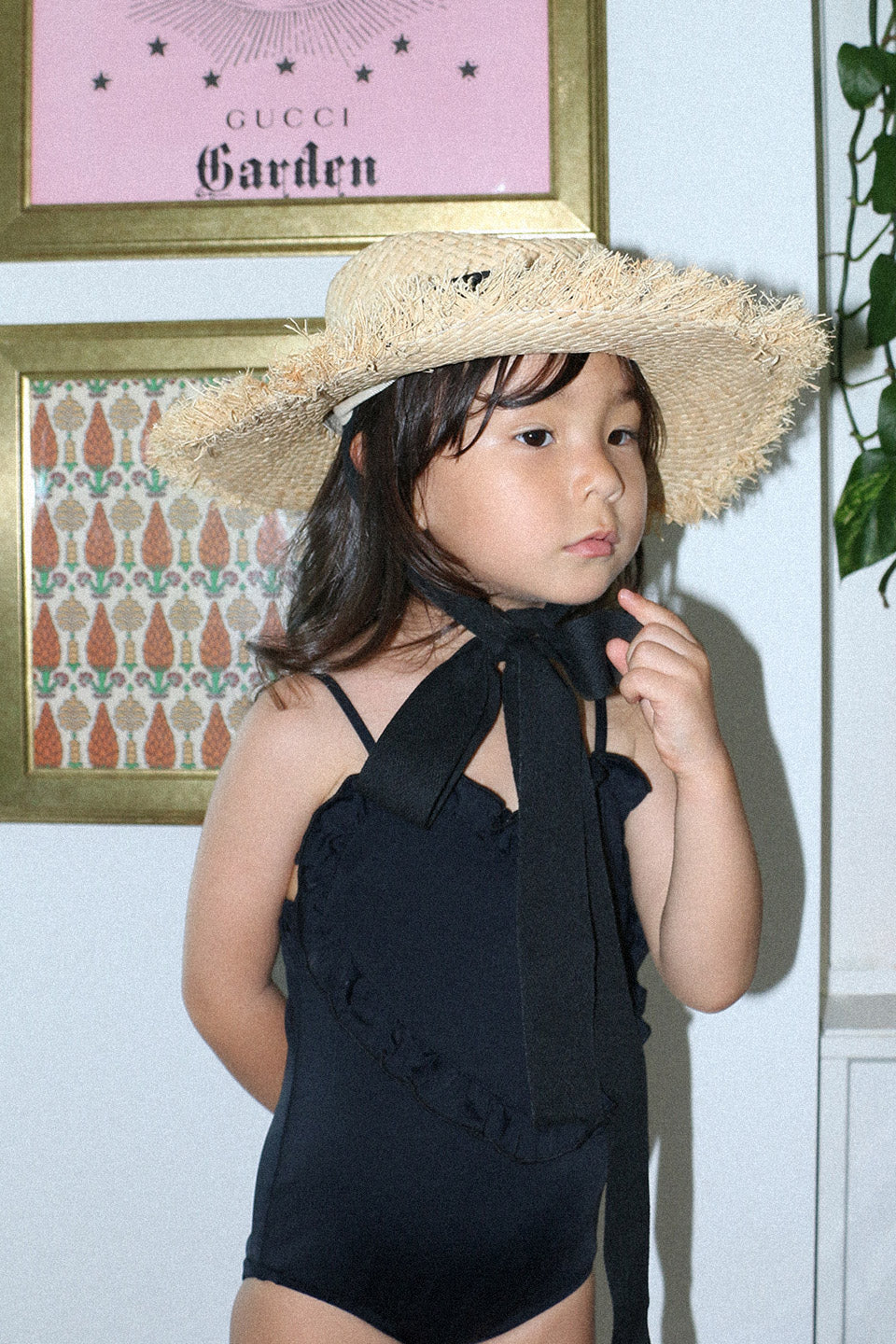 Heart-Shaped Swimwear for little girls and toddlers in black colorblock with ruffles and sleeveless. front photo lifestyle