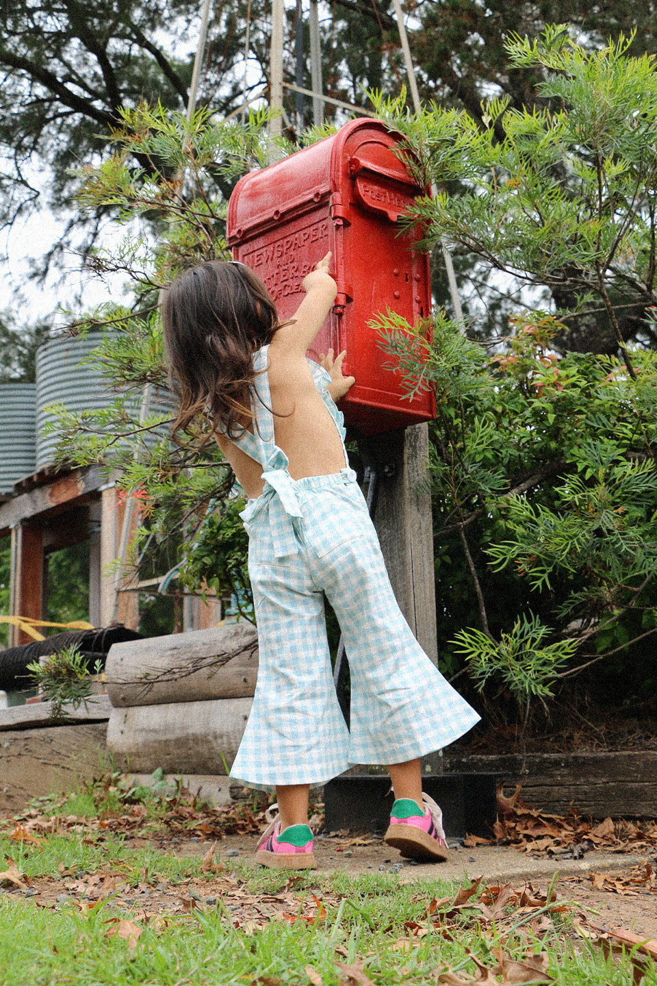 Get ready to fall in love with these Blue Gingham heart shape overalls! Made for little girls, these overalls feature a flared pant leg for added style and comfort. Perfect for any occasion, your little one will look adorable in these playful and unique overalls!. The flare pants add a playful touch to this charming piece. Your little one will surely steal the show in this sweet and stylish outfit. Lifestyle back